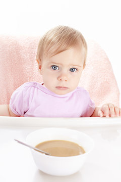 The baby eats children's porridge