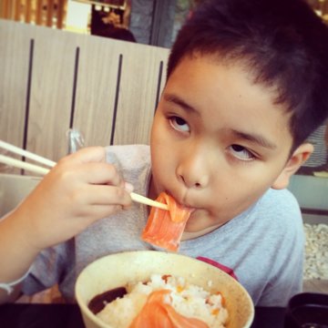 Boy Enjoy Eating Sushi