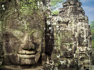 Fototapeta na wymiar Giant Stone Faces at Bayon Temple in Angkor, Cambodia