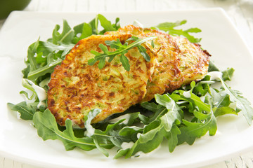 Zucchini fritters with arugula.