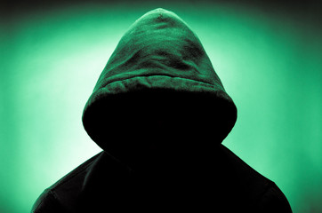 Man wearing hood with face in shadow - obrazy, fototapety, plakaty