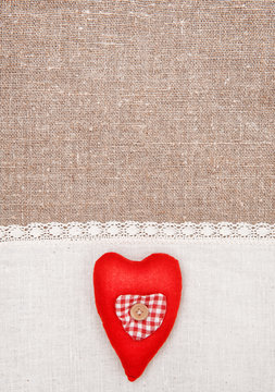 Textile heart and linen cloth on the burlap