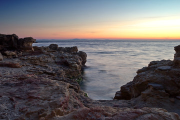 Fototapeta na wymiar Rocky beach at sunset