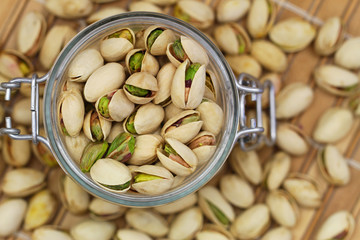 Pistachio nuts in vintage jar, close up
