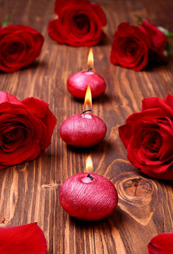 Romantic composition with red candles and roses. selective focus