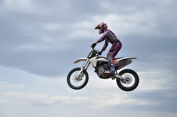 Fotobehang MX participant on a motorcycle in the air © VVKSAM