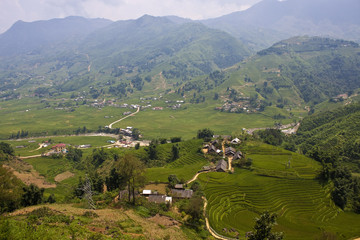 Fototapeta na wymiar Paddy fields and small villages in mountains of northern Vietnam