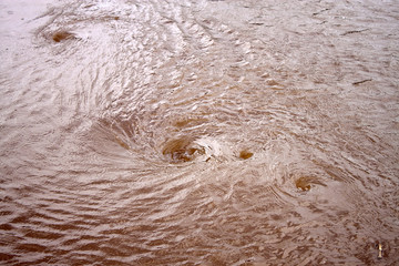 Whirlpools on a dirty river