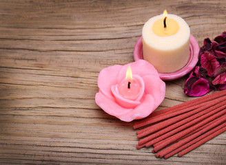 Spa. Burning candles with dried roses leaves and incense sticks
