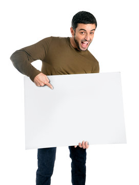 Attractive man showing and pointing blank billboard
