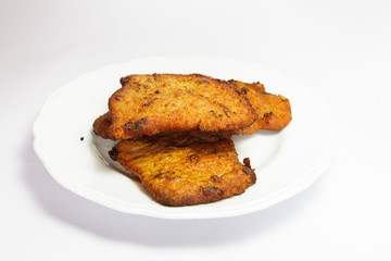 Four hot pork cutlets on white background