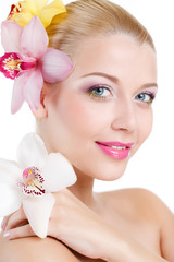 portrait of Beautiful woman With Orchid Flower in her hair