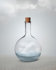 Small vintage glass bottle with water and cloud inside standing