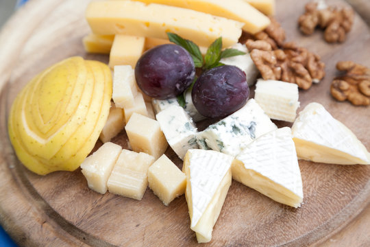 Cheese platter with grapes and selective focus