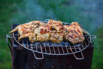 Grilled chicken thigh on the flaming grill 