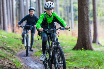 Fototapeta premium Healthy lifestyle - teenage girl and boy biking