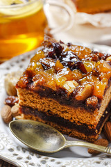 Delicious layer gingerbread cake decorated with dried fruits