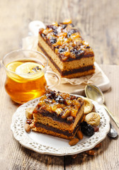 Delicious layer gingerbread cake decorated with dried fruits