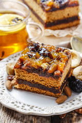 Delicious layer gingerbread cake decorated with dried fruits