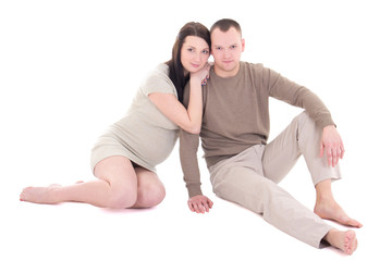 young pregnant couple sitting isolated on white background
