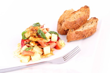 Chicken, cheese & vegetable salad with some bread on a plat