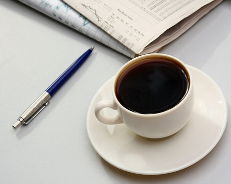 Cup of coffee near press.
