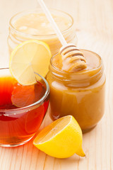 honey in jar and cup of healthy tea