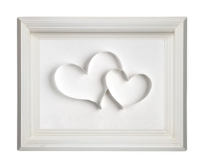 Two paper hearts in old wooden picture frame