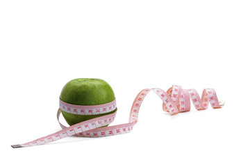 A green apple and a measurement tape
