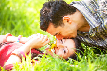 Couple Relaxing on Green Grass.Park.