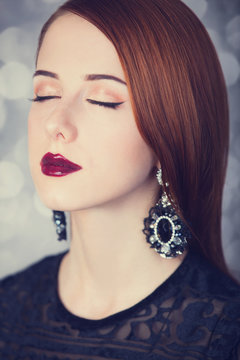 Beautiful redhead women with earrings.