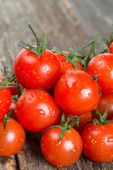 cherry tomatoes on rustic wooden surface