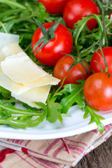 fresh salad from rucola, cherry tomatoes and parmesan cheese