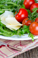 fresh salad from rucola, cherry tomatoes and parmesan cheese
