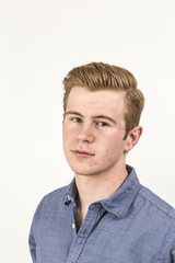 cool boy with red hair posing in studio