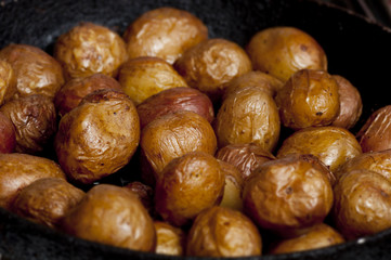 Baked potatoes in cast-iron frying-pan