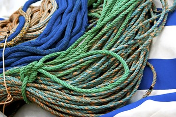 Bundles of mooring rope lies on striped cloth. - Powered by Adobe