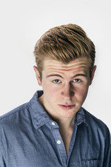 cool boy with red hair posing in studio