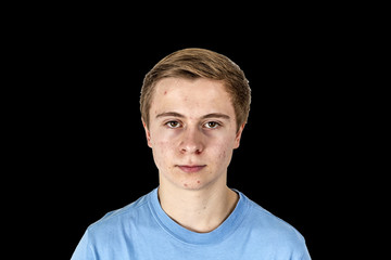 cool boy with blue shirt posing in studio