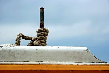 Rope coiled up round a pole on a fishing boat.