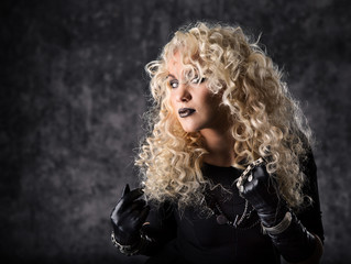 Woman blonde curly hair, beauty portrait in black