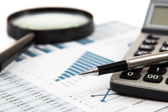 magnifying glass and pen over graph