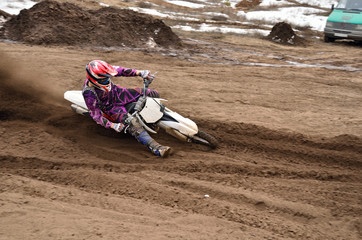 MX racing driver at the turning in the sandy ruts