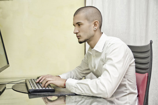 Young man working from home at computer