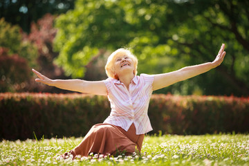 Meditation. Mature Pleased Woman Relaxing with Outspread Arms