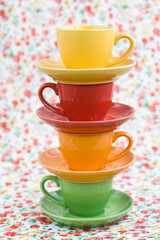 Four colorful cups on a background
