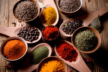 Assorted spices on wooden background