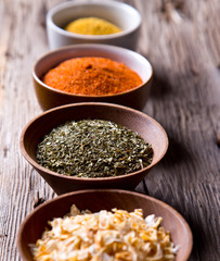 Assorted spices on wooden background