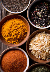 Assorted spices on wooden background