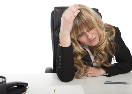 Worried businesswoman sitting thinking